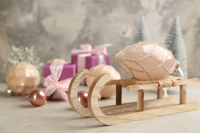 Beautiful Christmas composition with miniature sleigh on light table