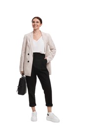 Beautiful businesswoman in suit with briefcase walking on white background