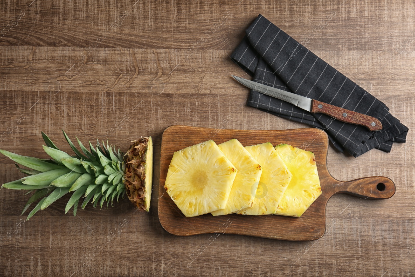 Photo of Cut fresh pineapple on wooden board