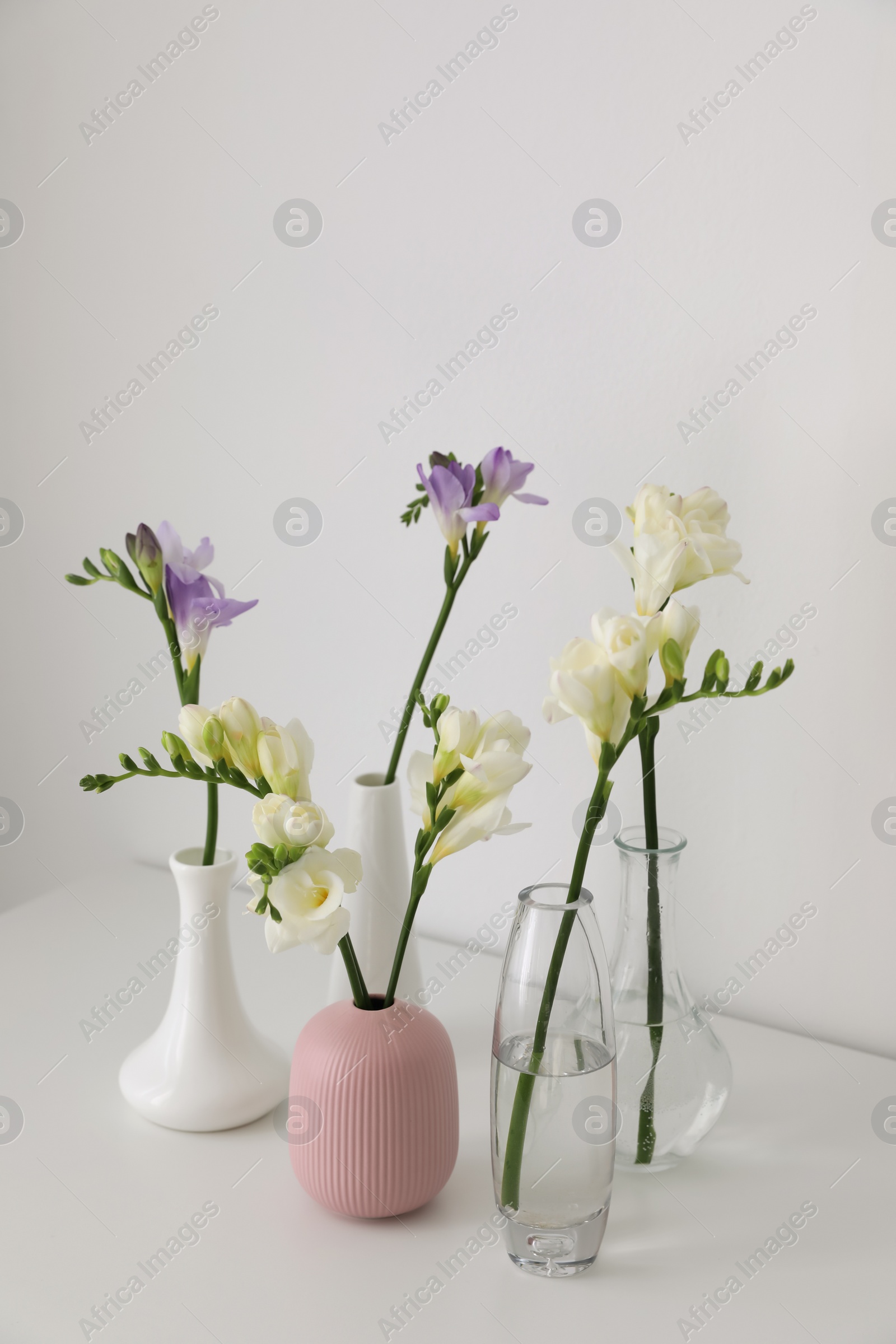 Photo of Beautiful spring freesia flowers on white table