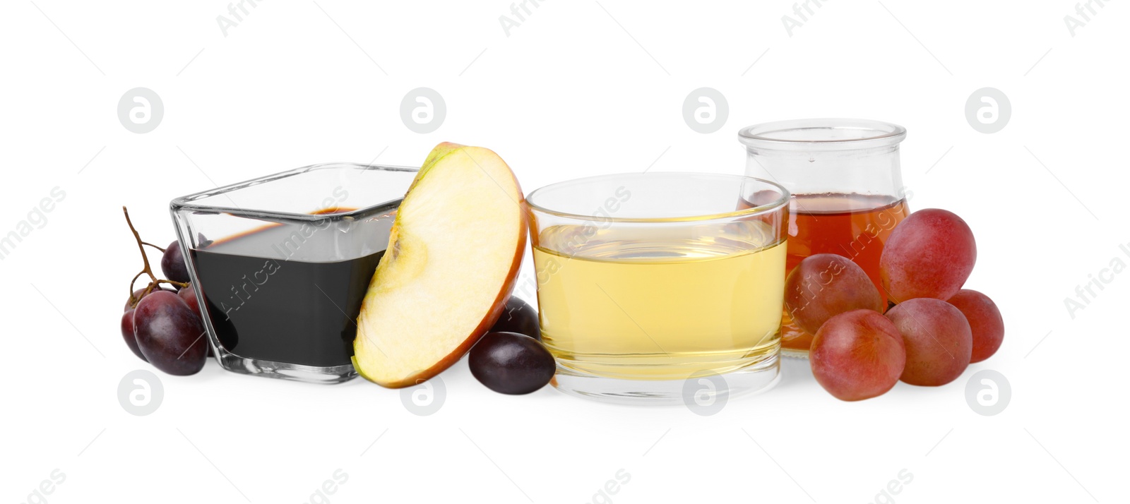 Photo of Different types of vinegar and ingredients isolated on white