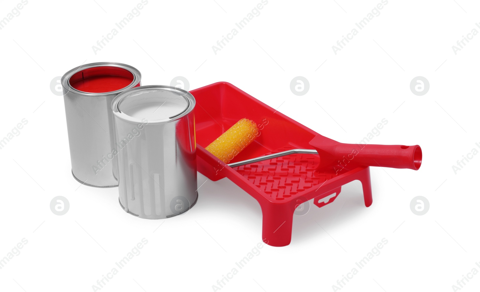 Photo of Cans of paints, tray and roller isolated on white
