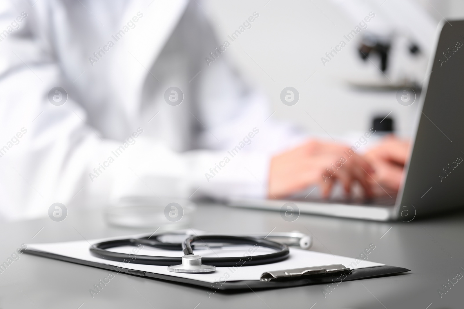 Photo of Medical students stuff on table against blurred background. Space for text