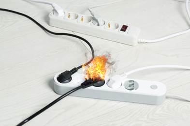 Image of Inflamed plug in power board - result of electrical short circuit
