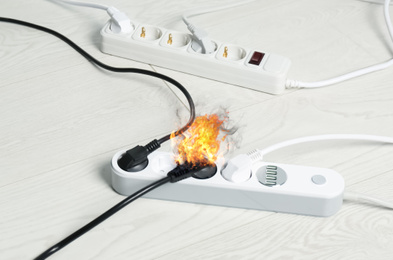 Inflamed plug in power board - result of electrical short circuit