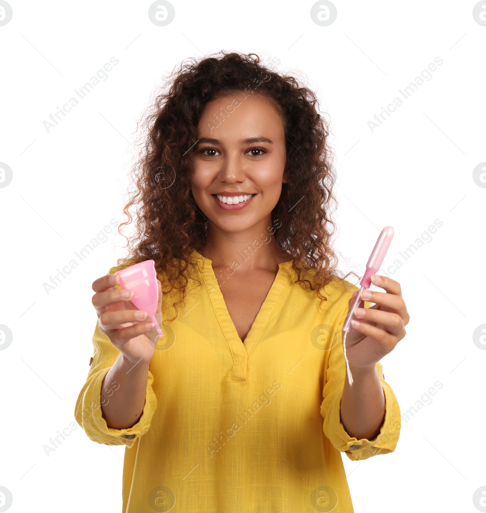 Photo of Young African American woman with menstrual cup and tampon on white background