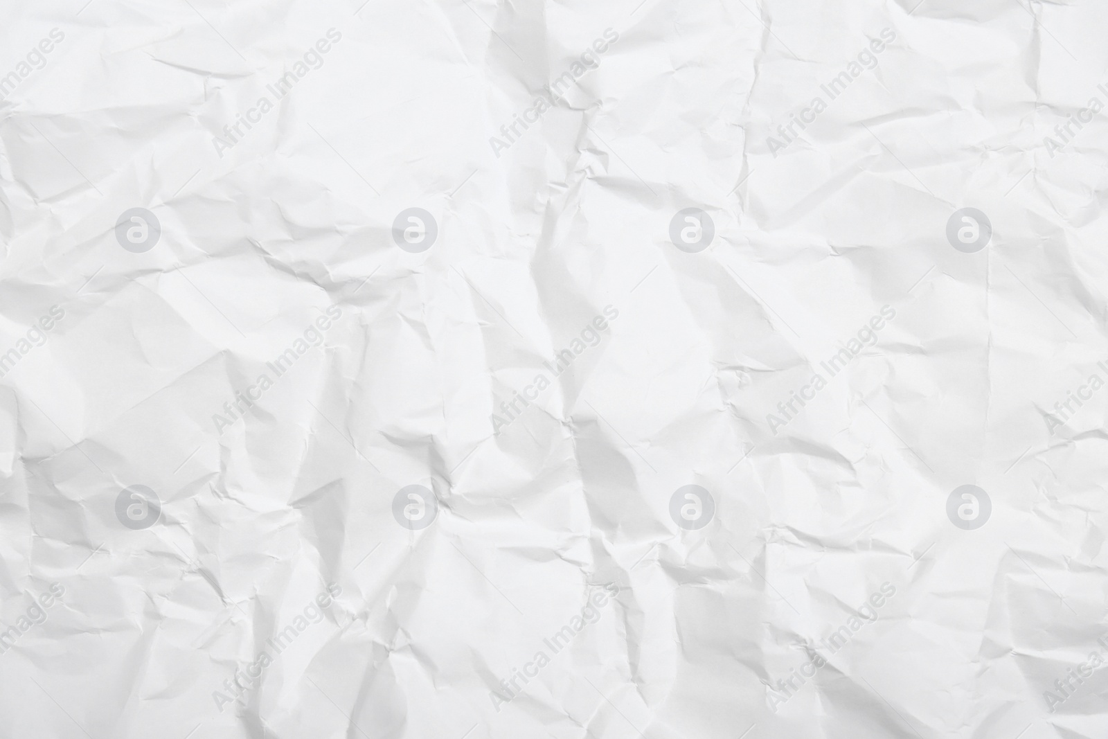 Photo of Sheet of white crumpled paper as background, closeup