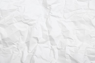 Photo of Sheet of white crumpled paper as background, closeup