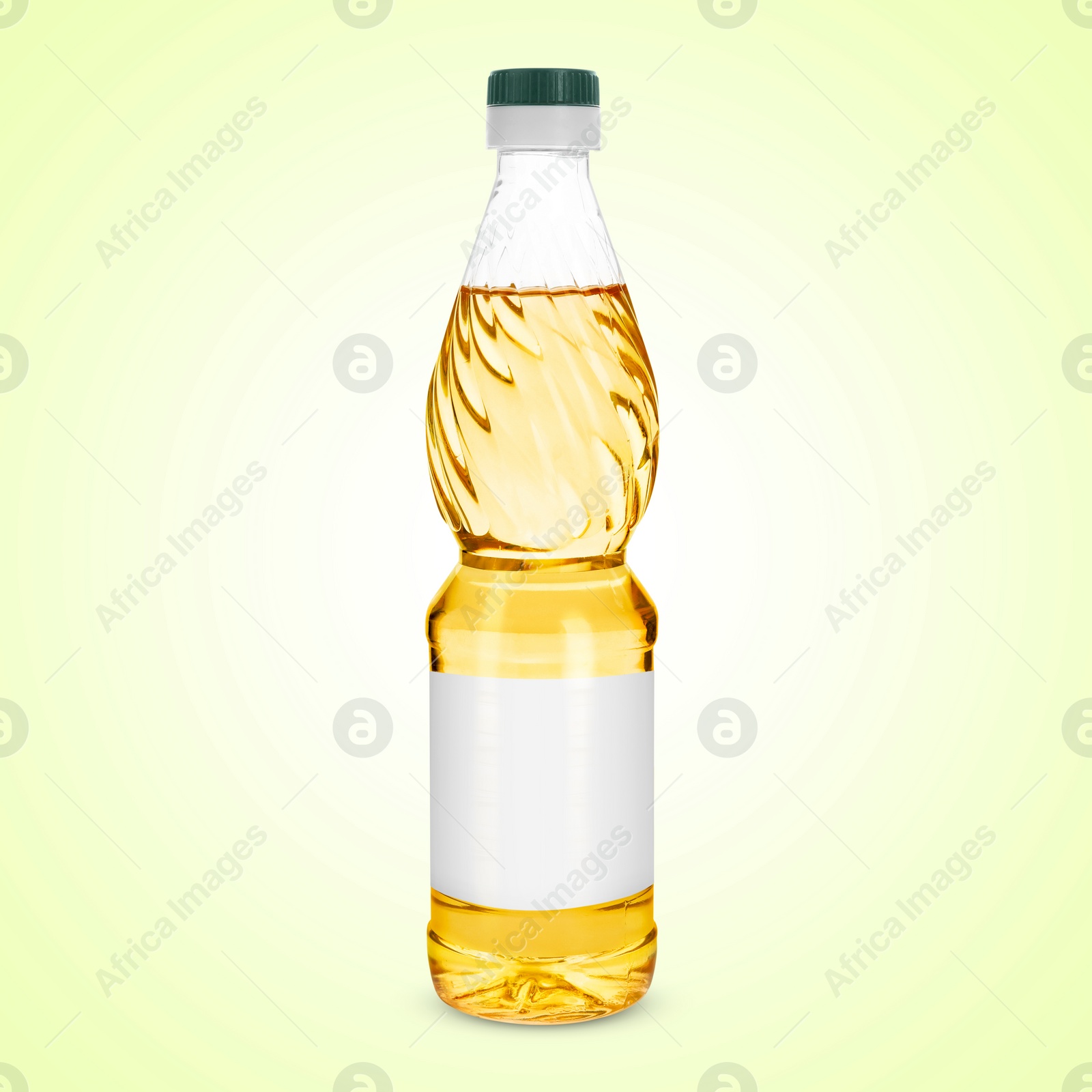 Image of Cooking oil in plastic bottle with empty label on light yellow background. Mockup for design