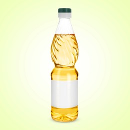 Image of Cooking oil in plastic bottle with empty label on light yellow background. Mockup for design