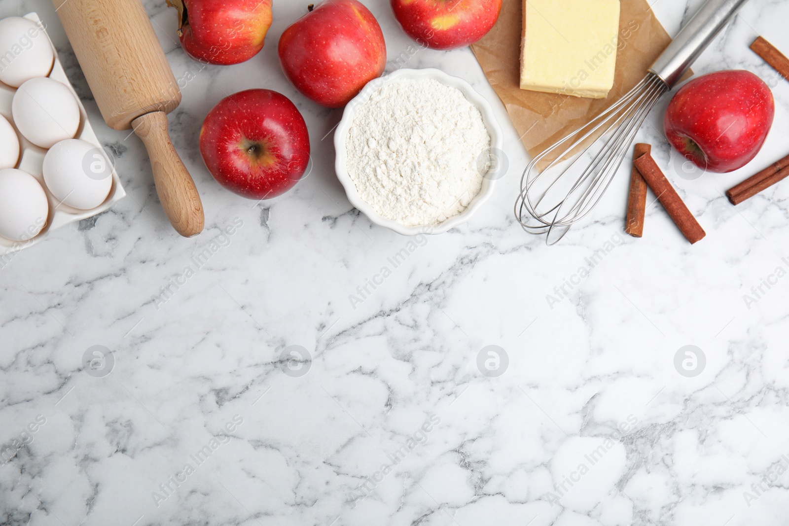 Photo of Traditional English apple pie ingredients on white marble table, flat lay. Space for text