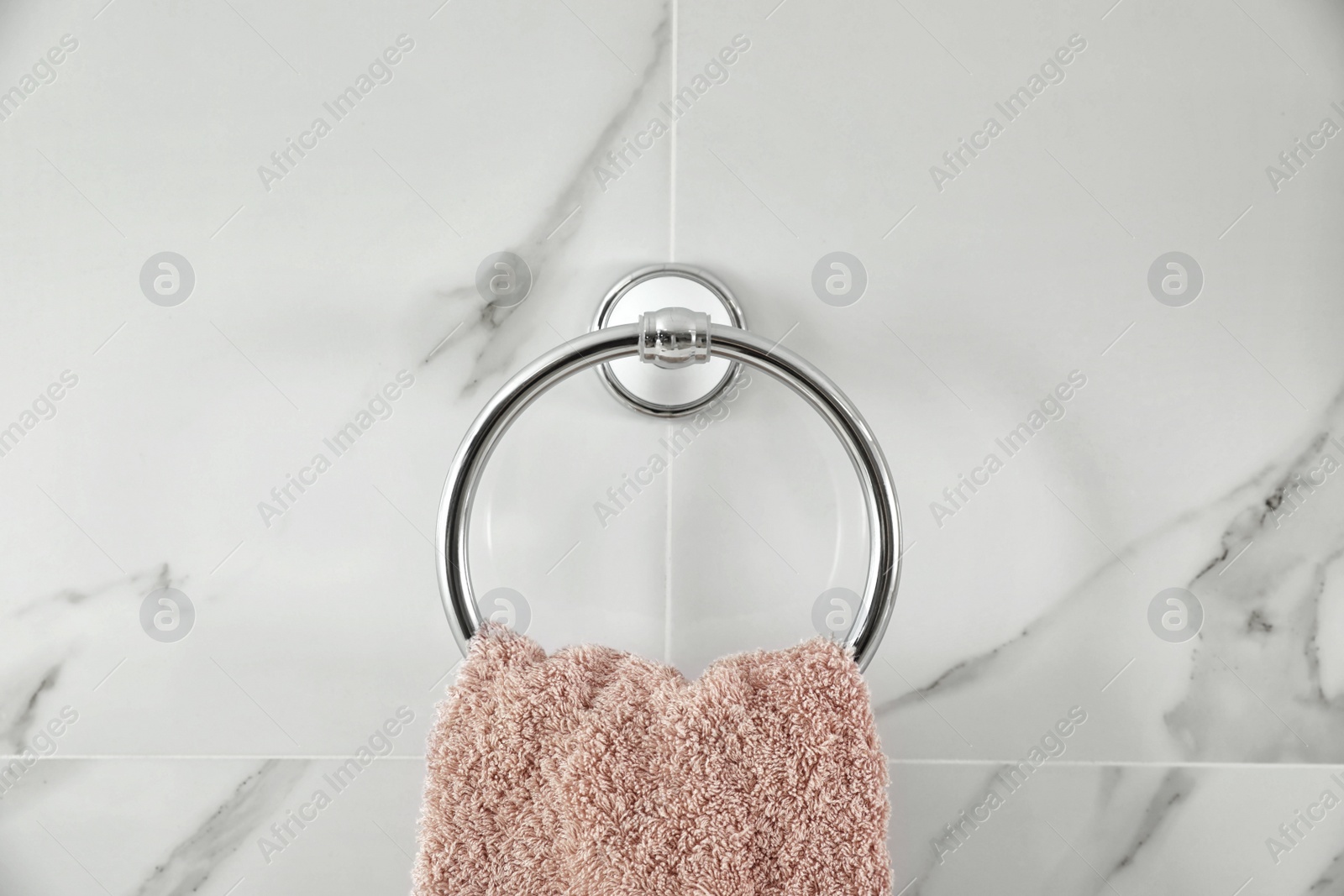 Photo of Holder with clean towel on light wall