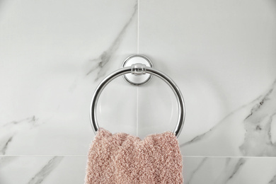 Photo of Holder with clean towel on light wall