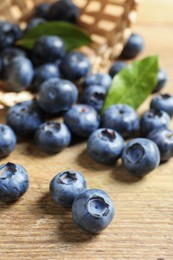 Photo of Fresh tasty blueberries on wooden table, closeup
