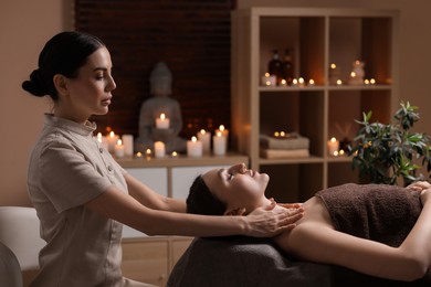 Photo of Spa therapy. Beautiful young woman lying on table during massage in salon