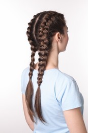 Photo of Woman with braided hair on light background, back view