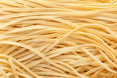 Photo of Quick cooking noodles as background, closeup view