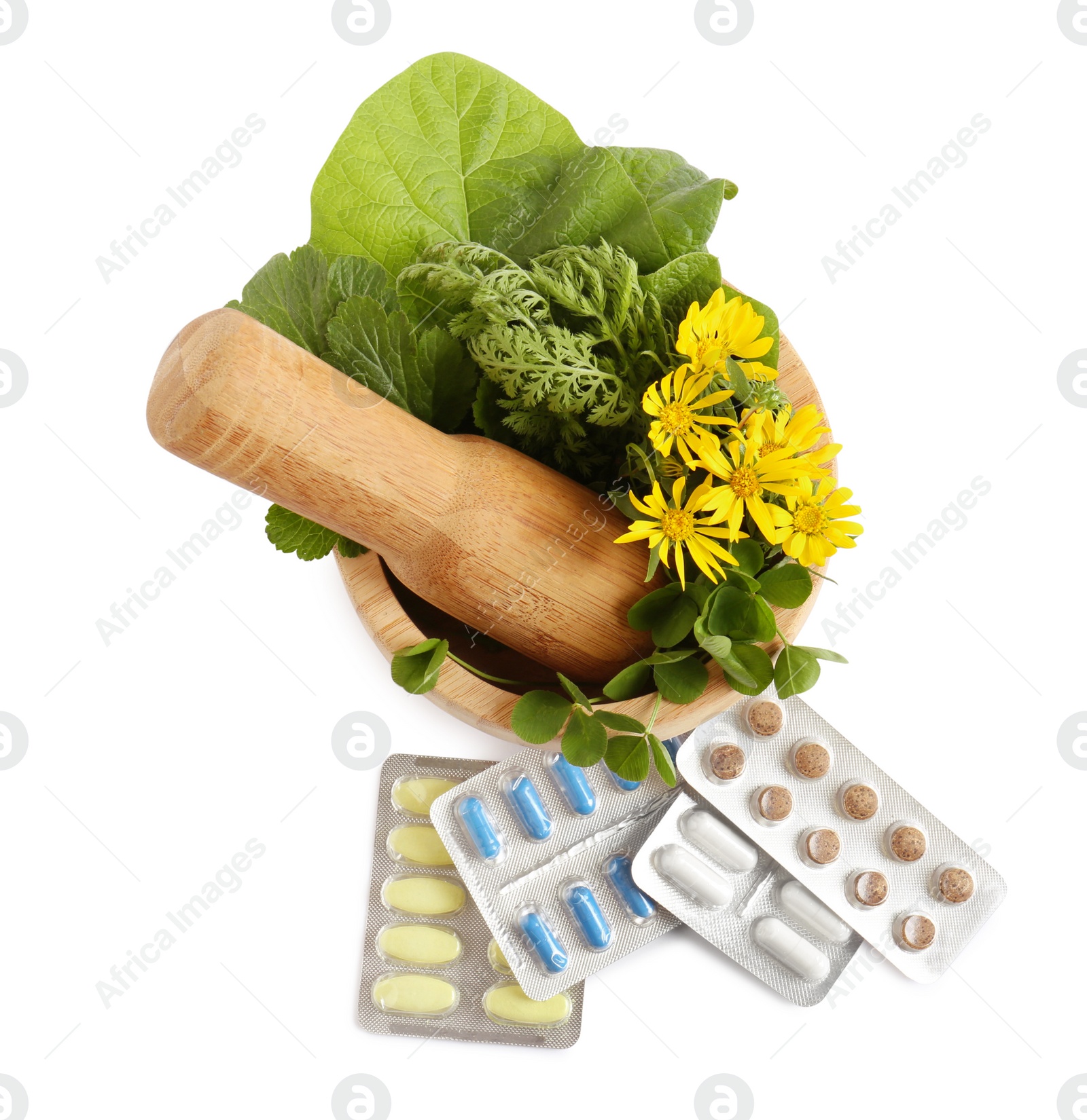 Photo of Mortar with fresh green herbs and pills on white background, top view