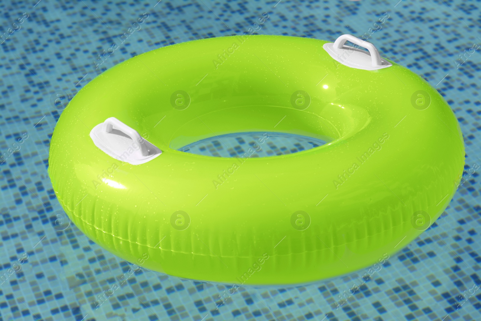 Photo of Light green inflatable ring floating in swimming pool