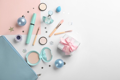 Flat lay composition with decorative cosmetic products on color background. Winter care