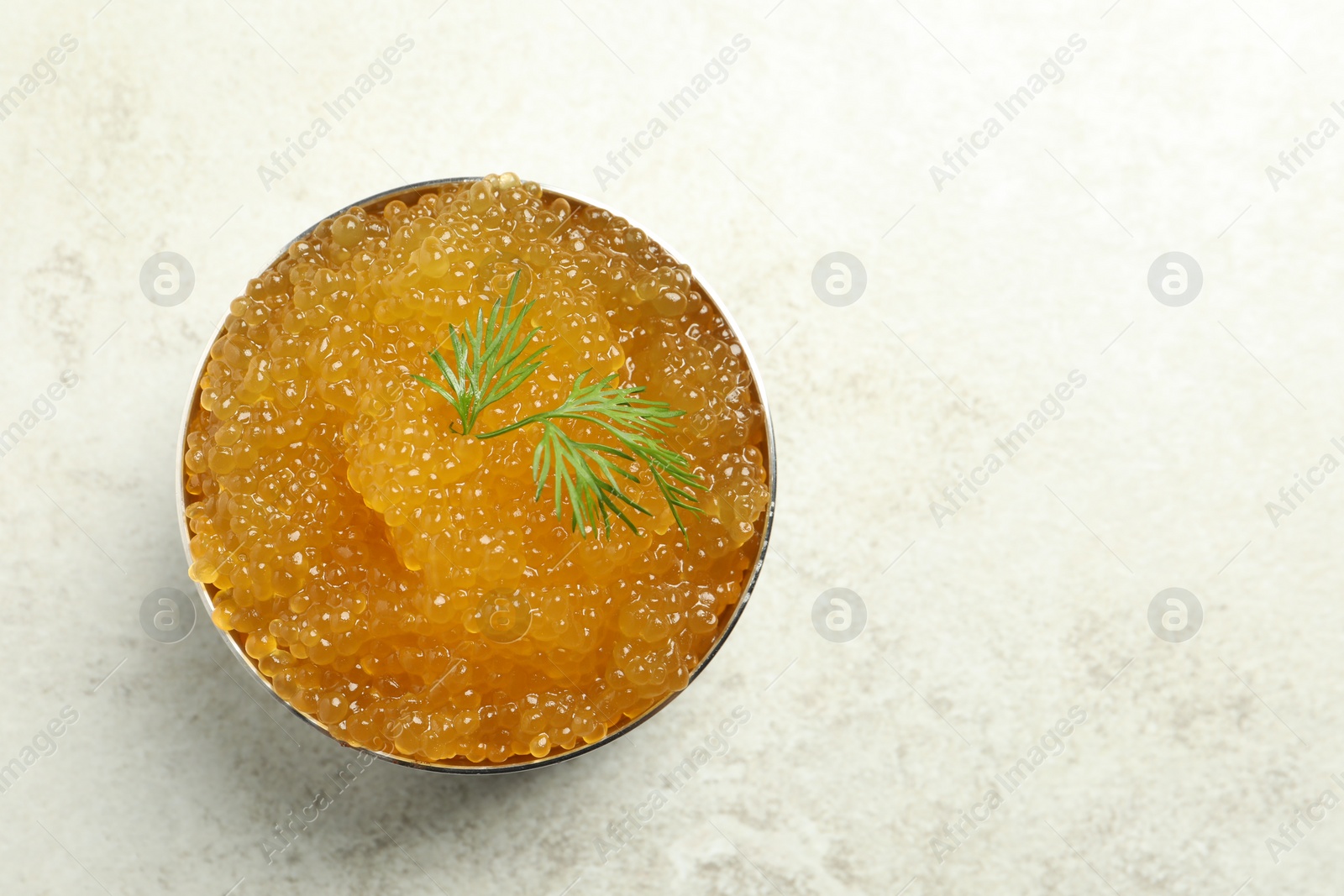 Photo of Fresh pike caviar in bowl on light table, top view. Space for text