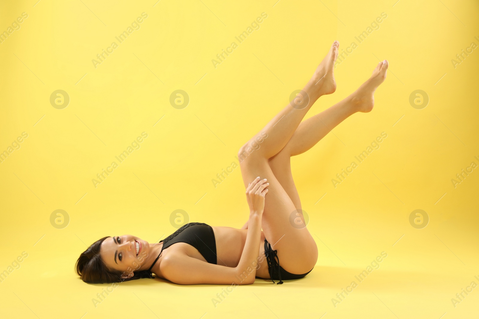 Photo of Full length portrait of attractive young woman with slim body in swimwear on color background