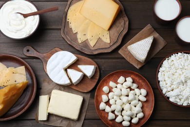 Photo of Flat lay composition with dairy products on wooden table