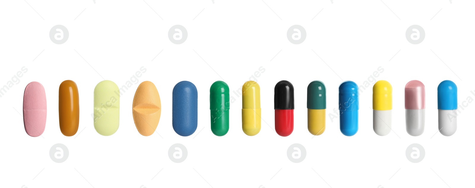 Image of Set of different color pills in row isolated on white