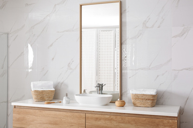 Large mirror and vessel sink in bathroom