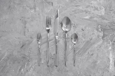 Photo of Beautiful cutlery set on grey table, flat lay