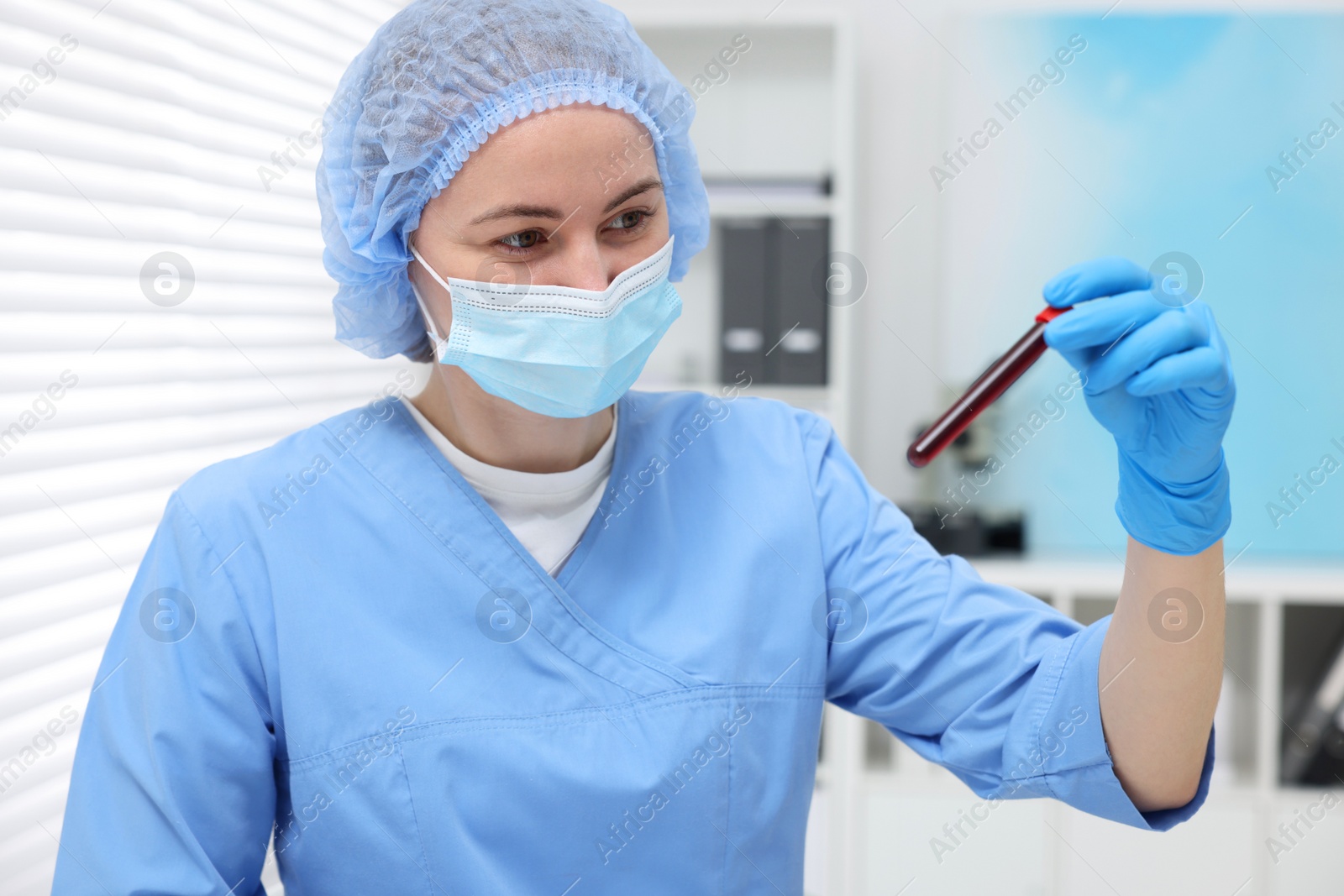 Photo of Laboratory testing. Doctor with blood sample in tube at hospital