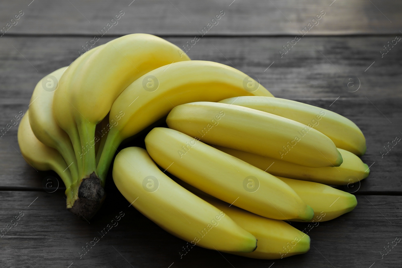 Photo of Ripe yellow bananas on wooden table, flat lay