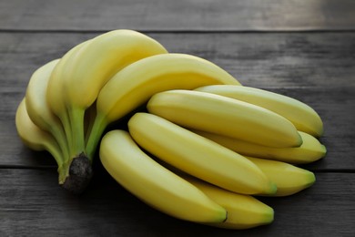 Ripe yellow bananas on wooden table, flat lay