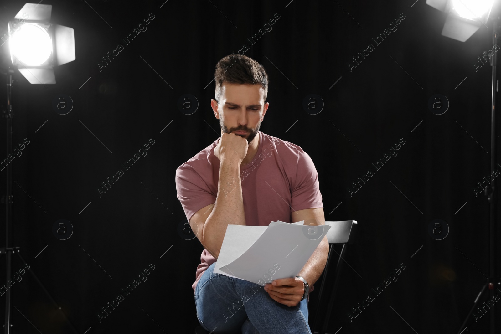 Photo of Professional actor reading his script during rehearsal in theatre