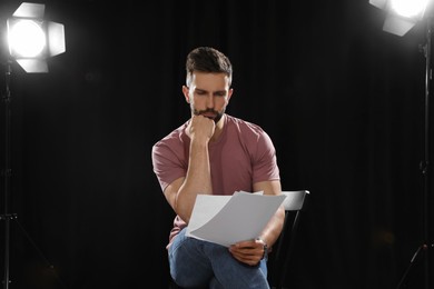 Photo of Professional actor reading his script during rehearsal in theatre