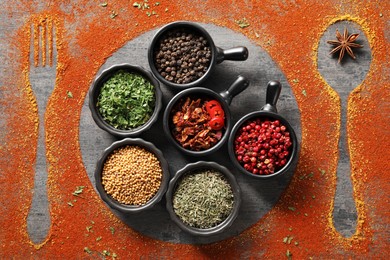 Photo of Different spices, silhouettes of cutlery and plate on grey table, flat lay