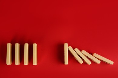 White domino tiles on red background, flat lay. Space for text