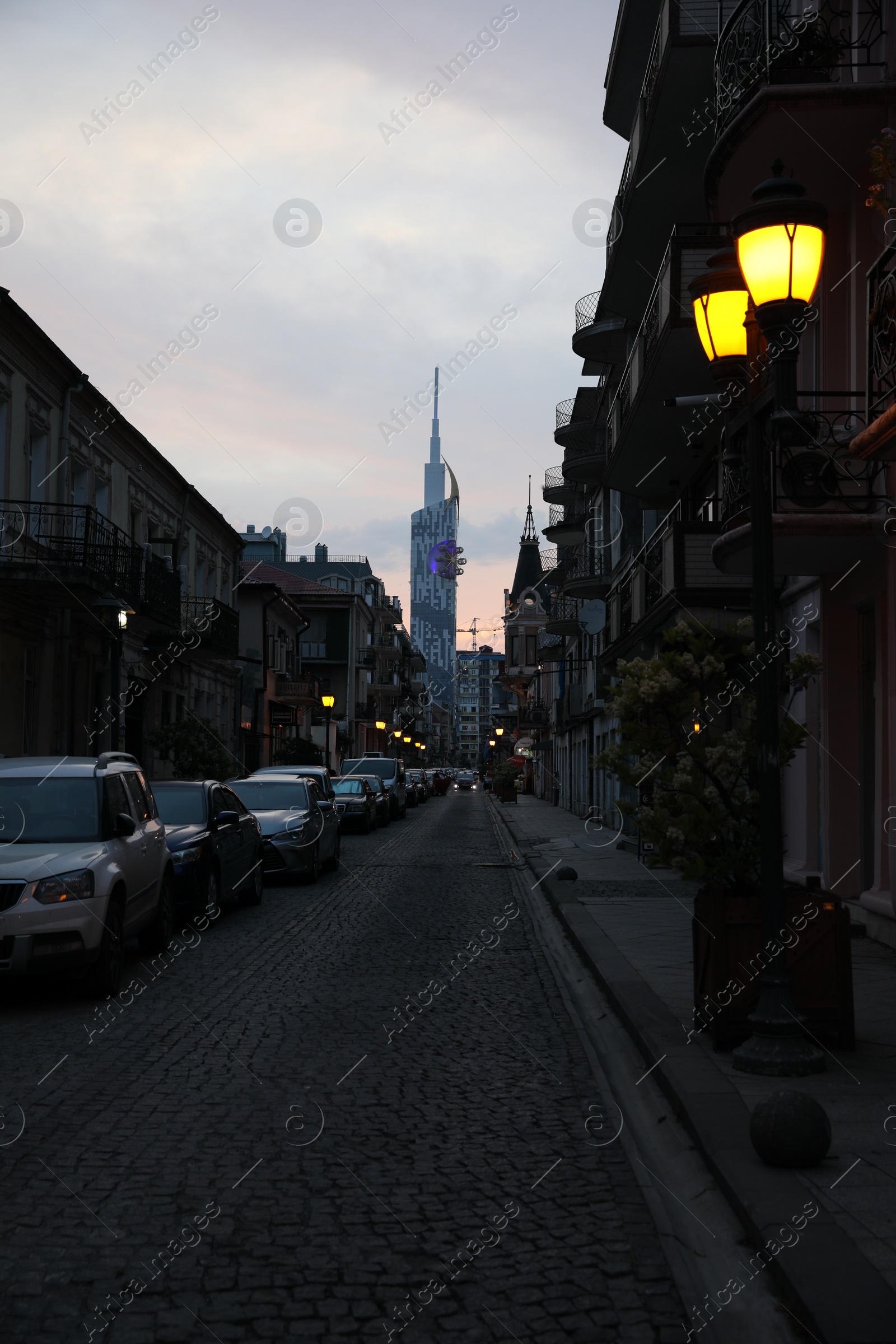 Photo of BATUMI, GEORGIA - MAY 31, 2022: Beautiful city street with buildings and parked cars in evening