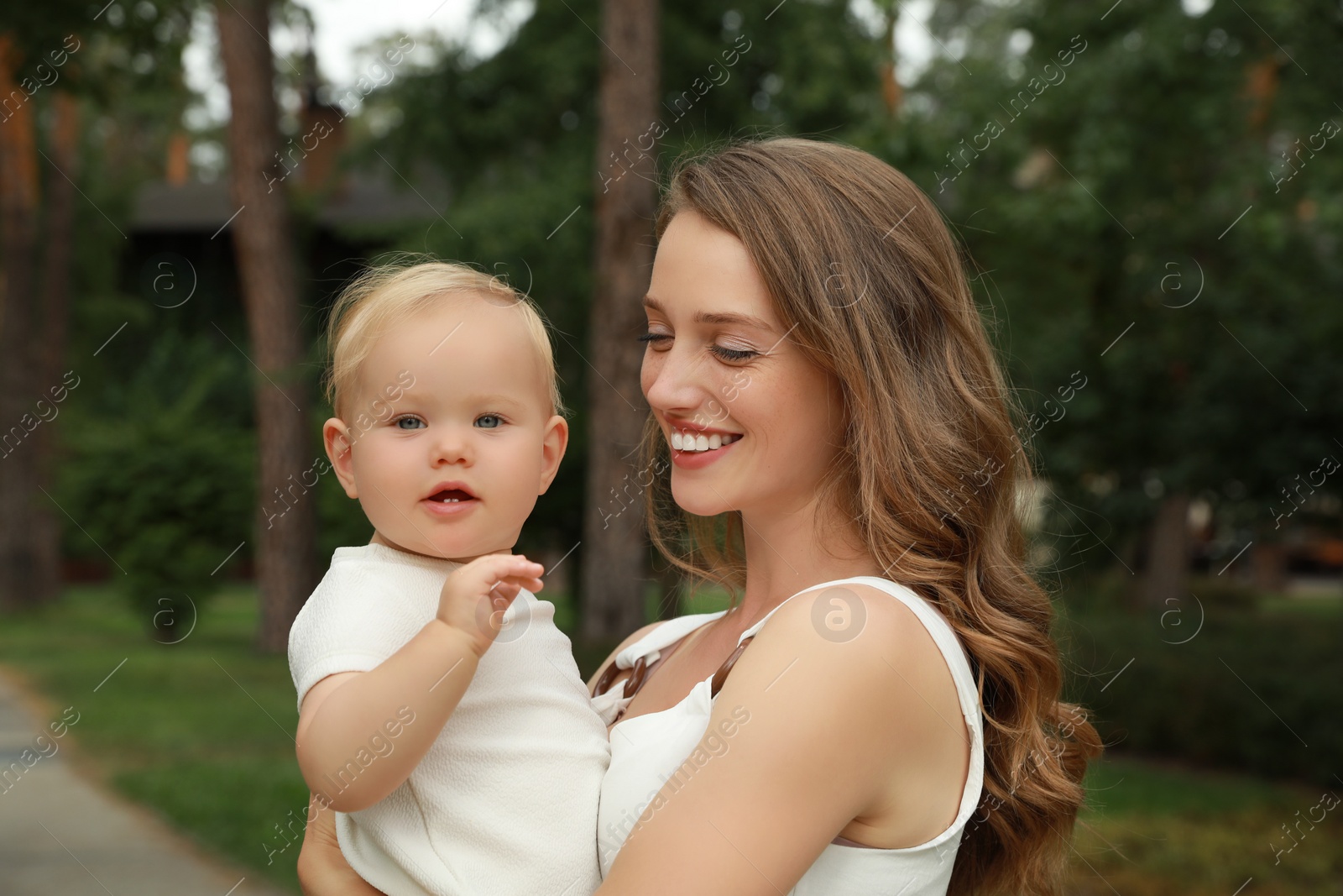 Photo of Mother with her cute baby spending time together outdoors