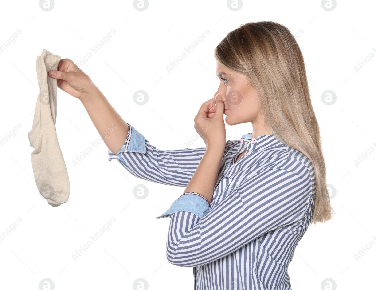 Photo of Young woman feeling bad smell from dirty socks isolated on white