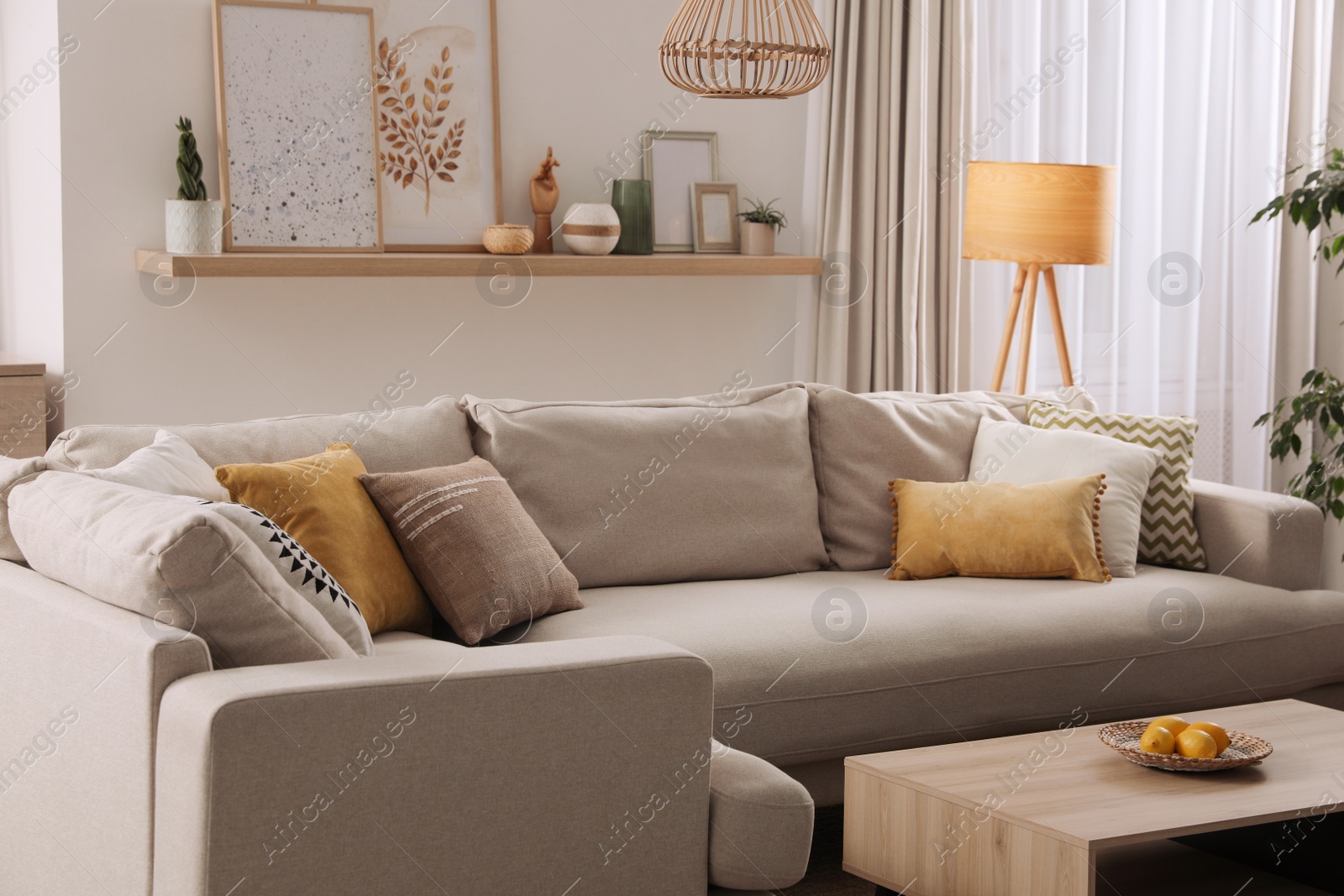 Photo of Stylish living room interior with comfortable grey sofa and coffee table