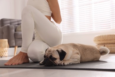 Photo of Woman with dog practicing yoga at home, closeup
