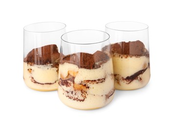 Photo of Delicious tiramisu in glasses isolated on white