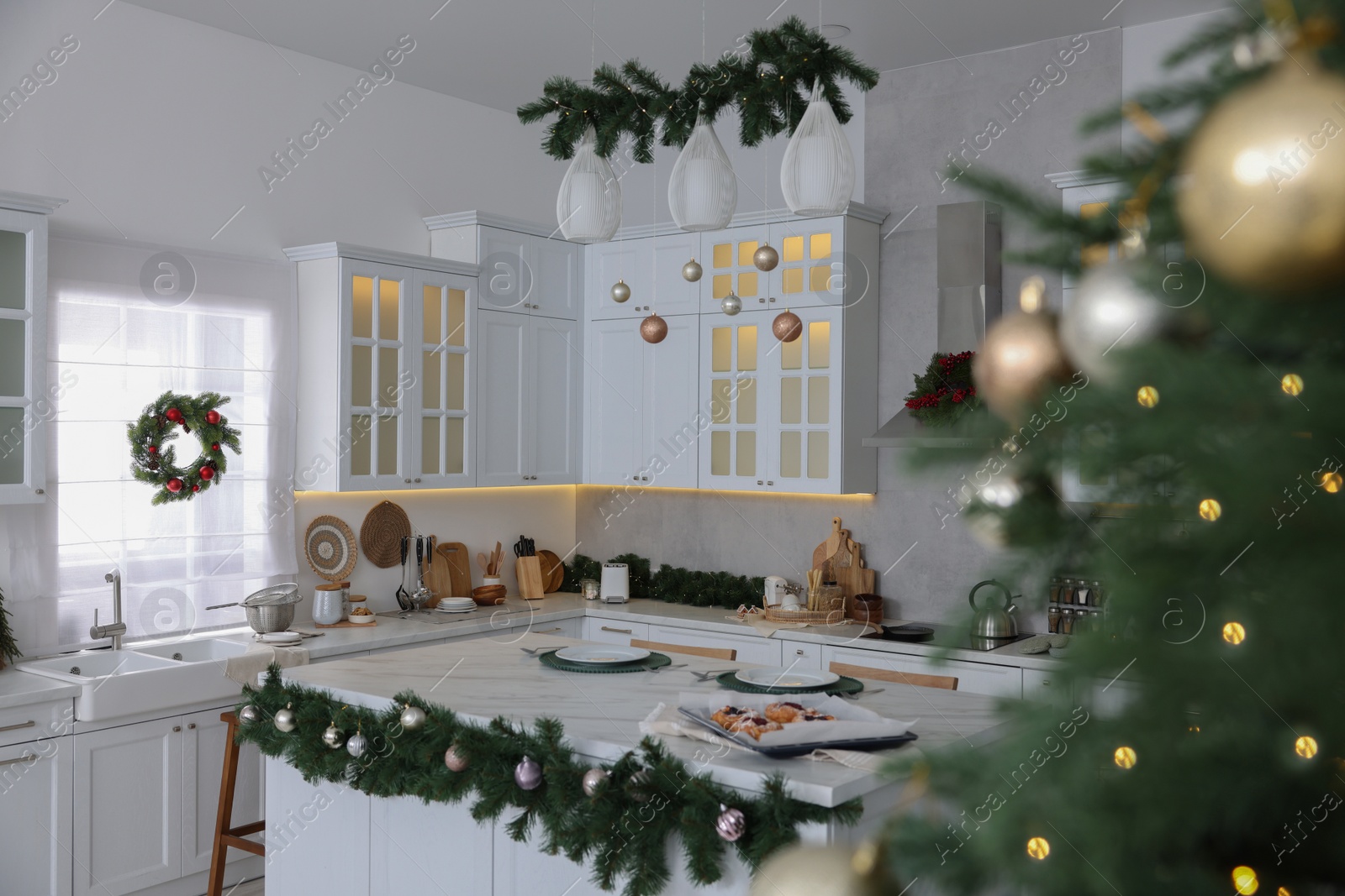 Photo of Cozy spacious kitchen decorated for Christmas. Interior design