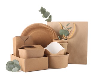 Eco friendly food packagings, disposable plate, paper bag and eucalyptus leaves isolated on white