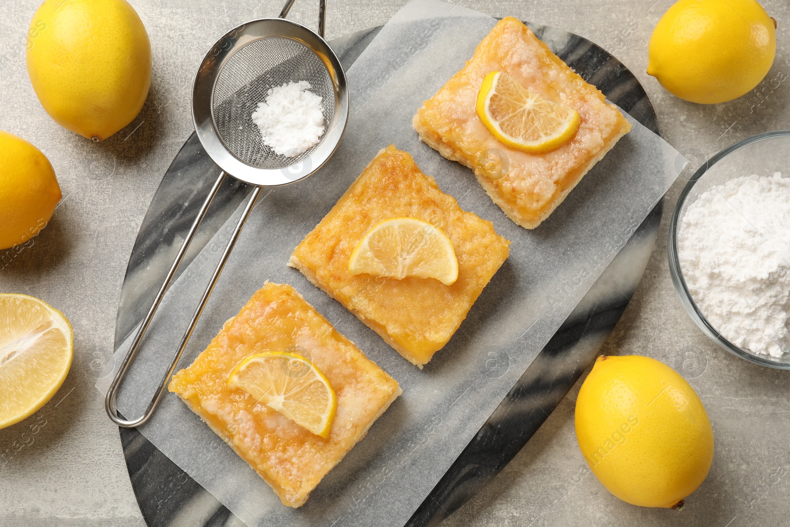 Photo of Tasty lemon bars on light grey table, flat lay