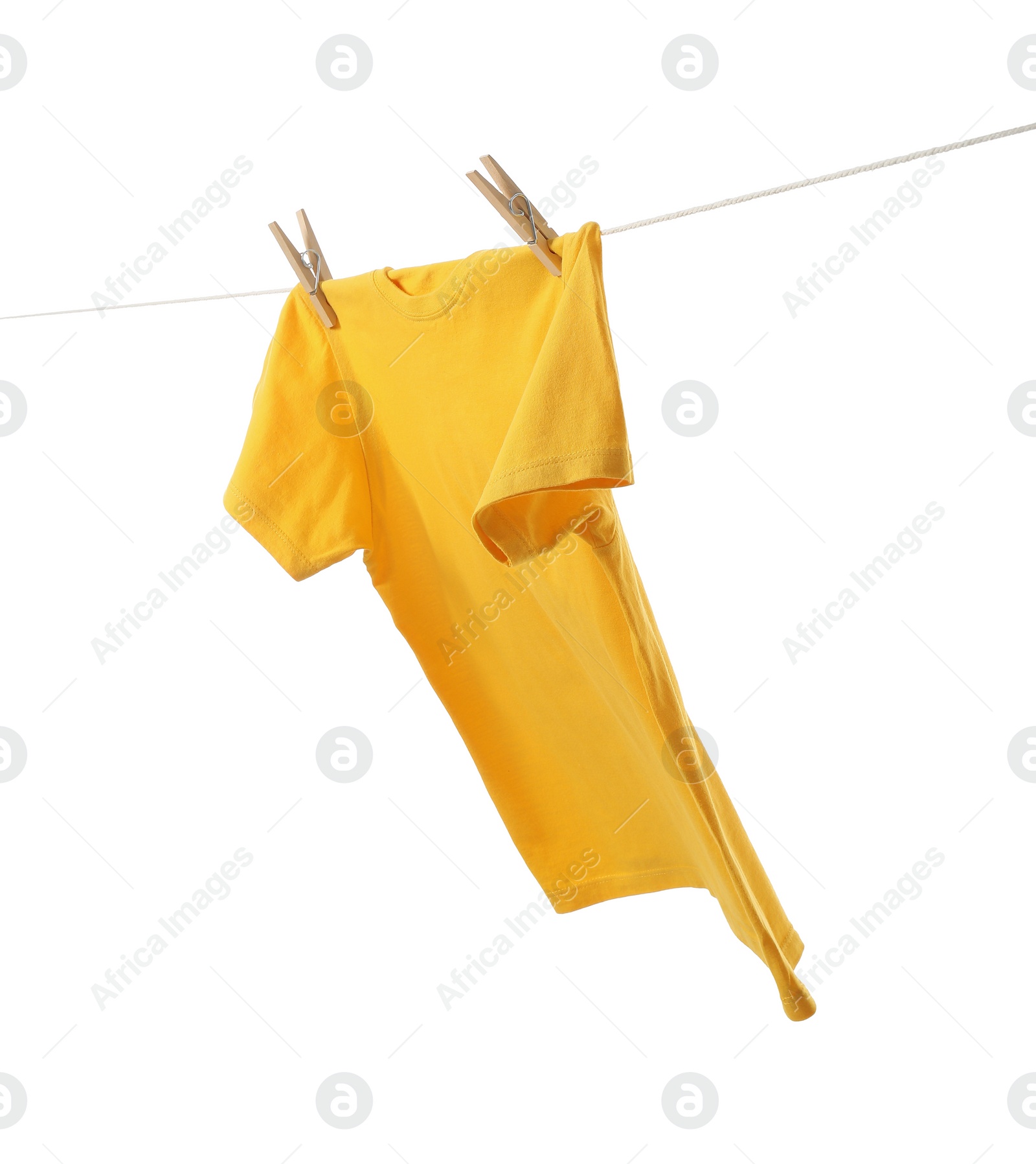 Photo of One yellow t-shirt drying on washing line isolated on white