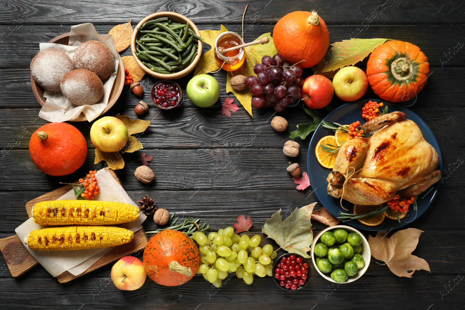 Photo of Frame made of turkey, autumn vegetables and fruits on dark wooden background, flat lay. Happy Thanksgiving day