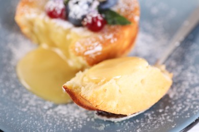 Tasty vanilla fondant with white chocolate and berries on plate, closeup