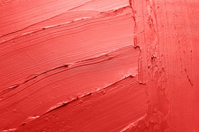 Photo of Red lipstick smears as background, closeup. Cosmetic product